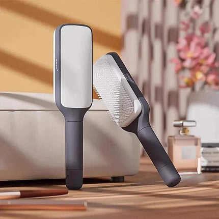 Two Self-Cleaning Hairbrush Hassle-Free Grooming & Smooth Styling on a wooden surface with a blurred indoor background