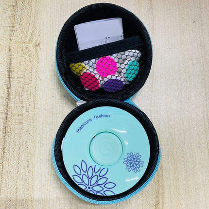Electric Baby Nail Trimmer Safe & Gentle Nail Care for Little Ones in a Round case with color-coded grinding heads on a wooden surface