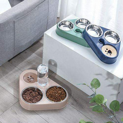Pet Food Bowls 3 in 1 Ergonomic & Safe Feeding Solution with multiple bowls on a white surface, next to a gray sofa.