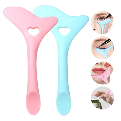 Two silicone sponges, one pink and one blue, with heart-shaped holes on a white background.