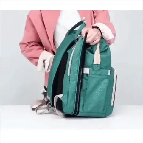 Image of a person demonstrating the Baby Diaper Backpack, highlighting its organized compartments and comfortable design.