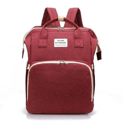 Red Baby Diaper Backpack  with a white label on a white background