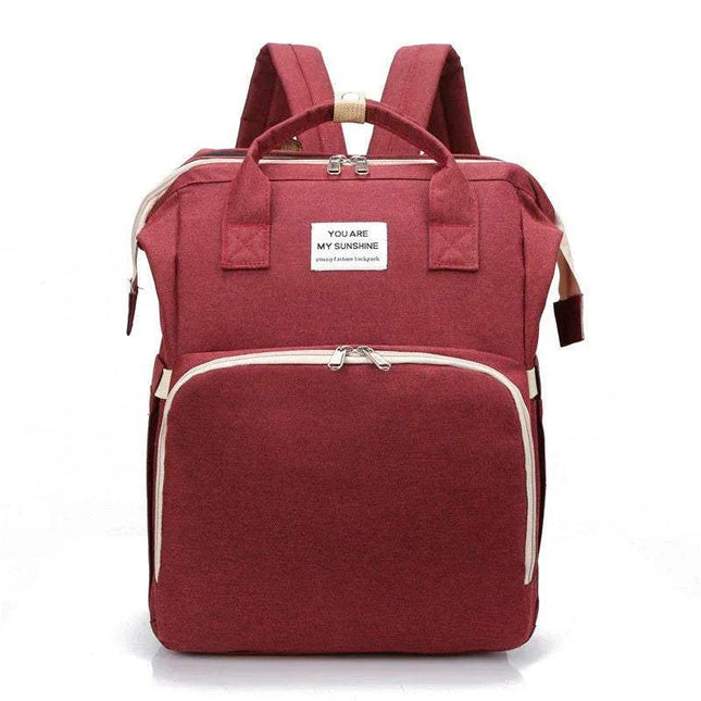 Red Baby Diaper Backpack  with a white label on a white background