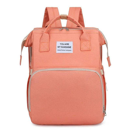 Pink Baby Diaper Backpack  with a motivational quote tag on a white background