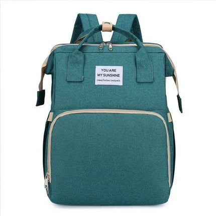 Green Baby Diaper Backpack with a visible brand label on a white background