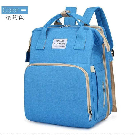 Light Blue Baby Diaper Backpack  with a label on a white background