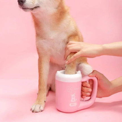 Dog using a pink Pet Foot Washing Cup Portable Paw Cleaner for Dogs & Cats  on a pink background
