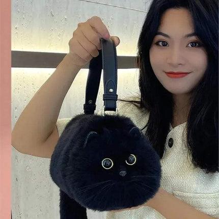 Person holding a black fluffy Ultra-Soft Convertible Cat Handbag Stylish & Playful Feline-Inspired Bag