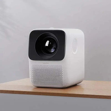 close-up of a White WANBO T2 Max Projector 1080P on a wooden surface with a gray background