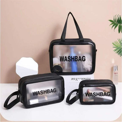 Set of three black Portable Transparent Waterproof Travel Wash & Makeup Bag with transparent fronts on a beige background