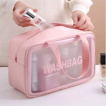 Pink Portable Transparent Waterproof Travel Wash & Makeup Bag with 'SK-II' skincare product being taken out, on a neutral background.