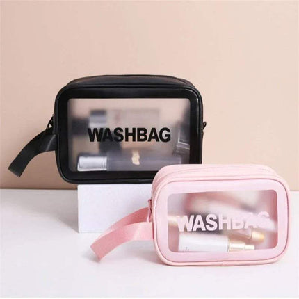 Black and pink Portable Transparent Waterproof Travel Wash & Makeup Bag with 'WASHBAG' text on a beige background