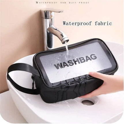 Black Portable Transparent Waterproof Travel Wash & Makeup Bag labeled 'WASHBAG' being rinsed under running water from a faucet.