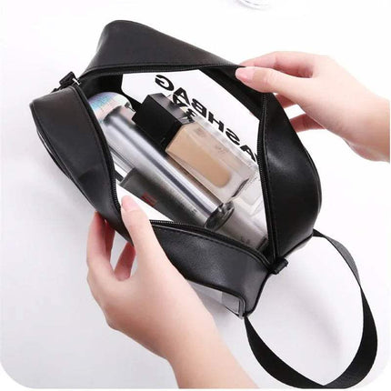 Black Portable Transparent Waterproof Travel Wash & Makeup Bag with cosmetic products held by a hand on a white background