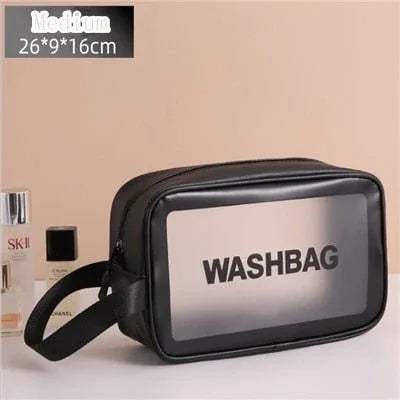Black Portable Transparent Waterproof Travel Wash & Makeup Bag with 'WASHBAG' text on a beige background