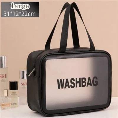 Black Portable Transparent Waterproof Travel Wash & Makeup Bag with transparent front panel on a beige background