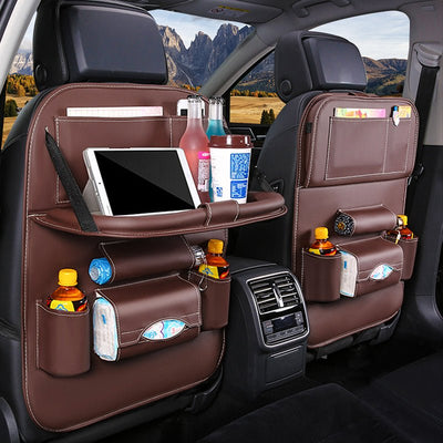Car Back Seat Organizer Storage Bag with foldable table, drink holders, and tablet storage in a car.