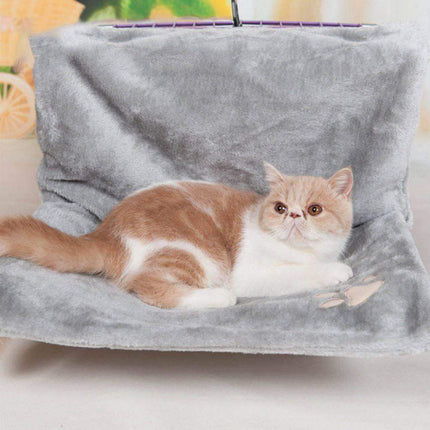 Cat sitting on a gray Cat Hanging Bed Plush Orthopedic Perch with a blurred background
