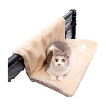 Cat sitting on a Cat Hanging Bed Plush Orthopedic Perch attached to a bed.