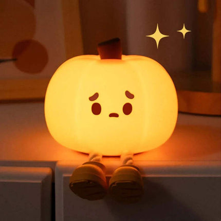 Cute Pumpkin Night Light with a face on a shelf.