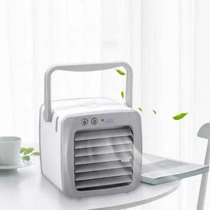 Mini Air Conditioner on a white table with a cup and leaves in the background