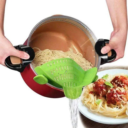 Person using a green Universal Silicone Strainer Clip to transfer pasta from a pot to a plate.