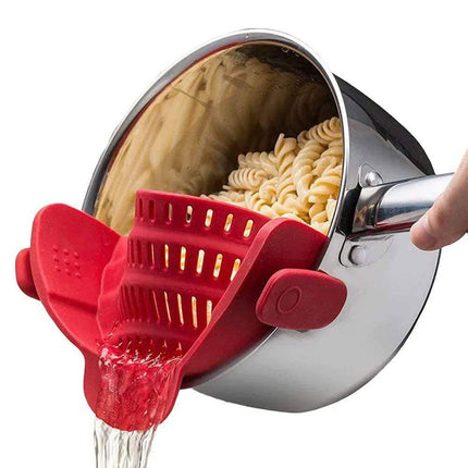 Red Universal Silicone Strainer Clip being used to drain pasta from a pot.